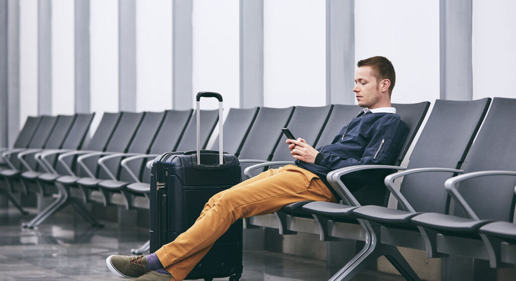 A man Sitting on a terminal through the services of best travel agency