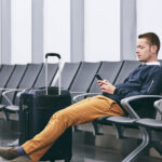 A man Sitting on a terminal through the services of best travel agency