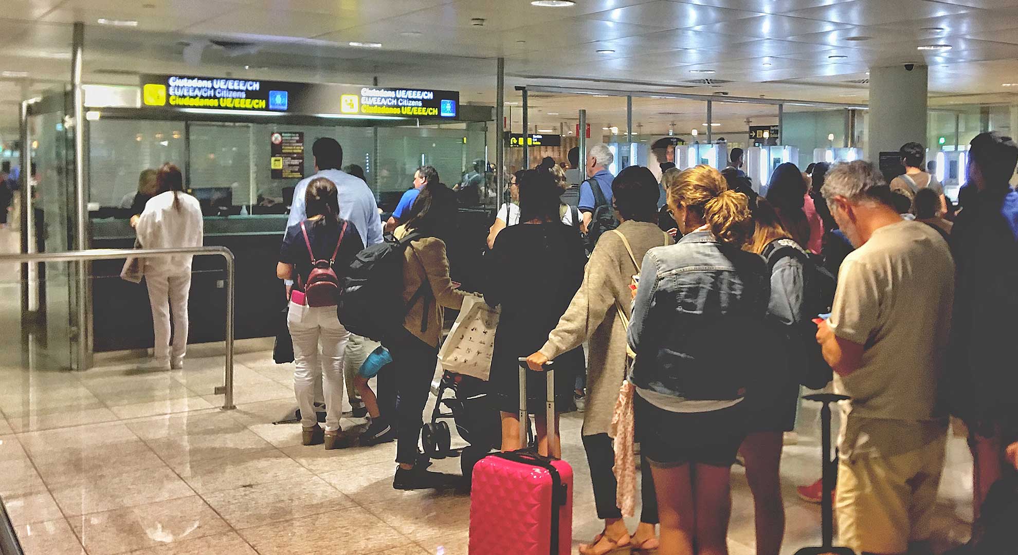 Travelers standing in line at customs and immigration for entry into Canada, with a focus on efficient visa processing and travel services for international visitors."



